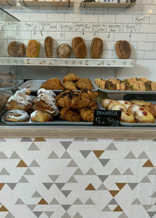 different types of pastries displayed behind a glass display