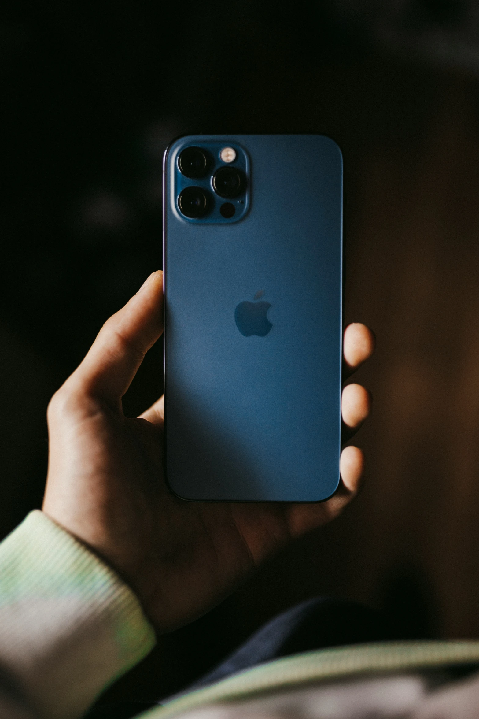 the iphone 12 pro is in the palm of someone's hand