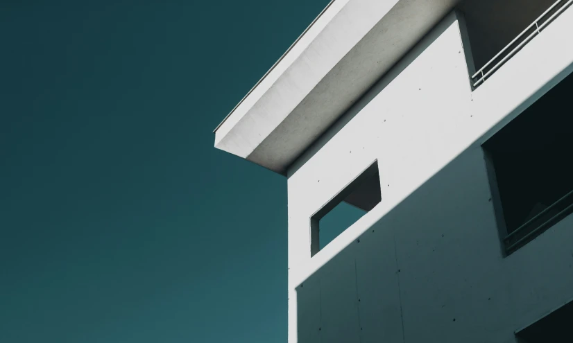 the corner of a white building with an open window