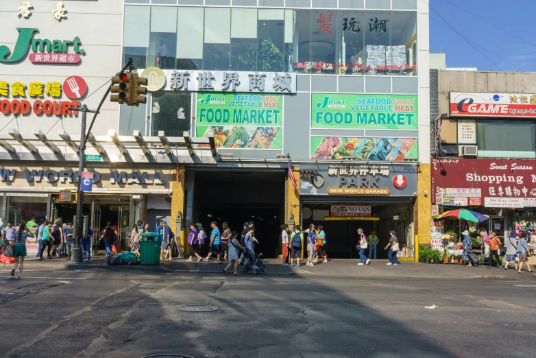 many people stand on the street outside a grocery store