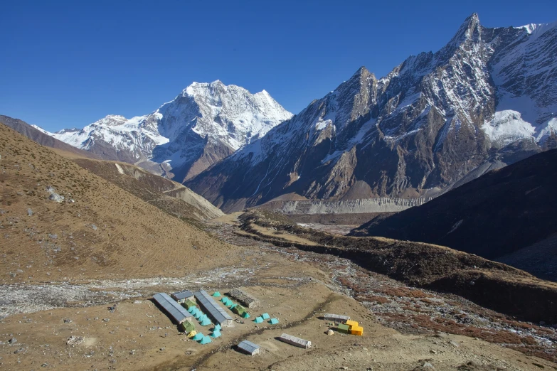 several tents set up on a mountain side in the mountains