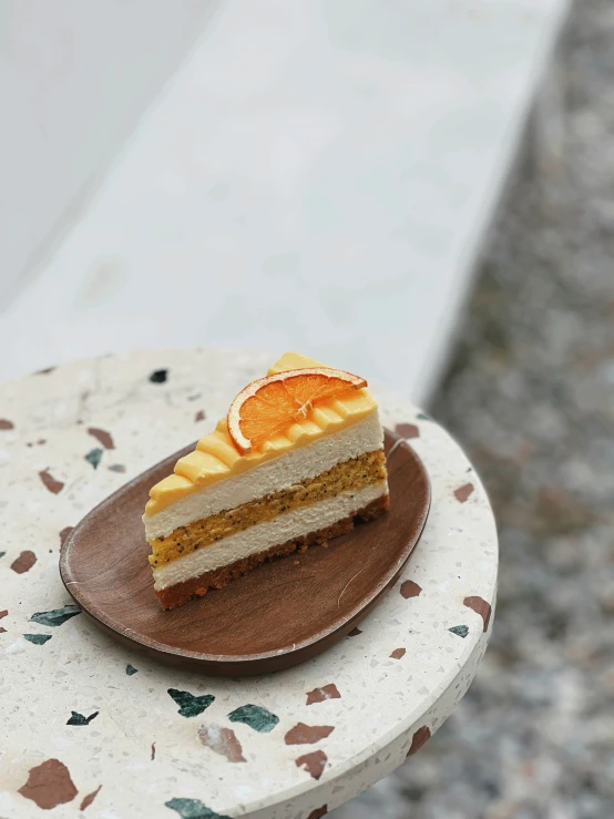 a slice of cake with orange slices sits on the table