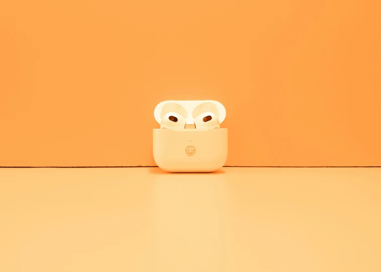 an orange wall with two owl faces in a cellphone case