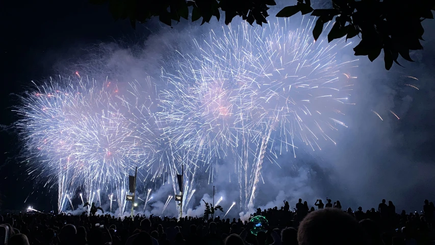 people watching a fireworks show while they watch soing