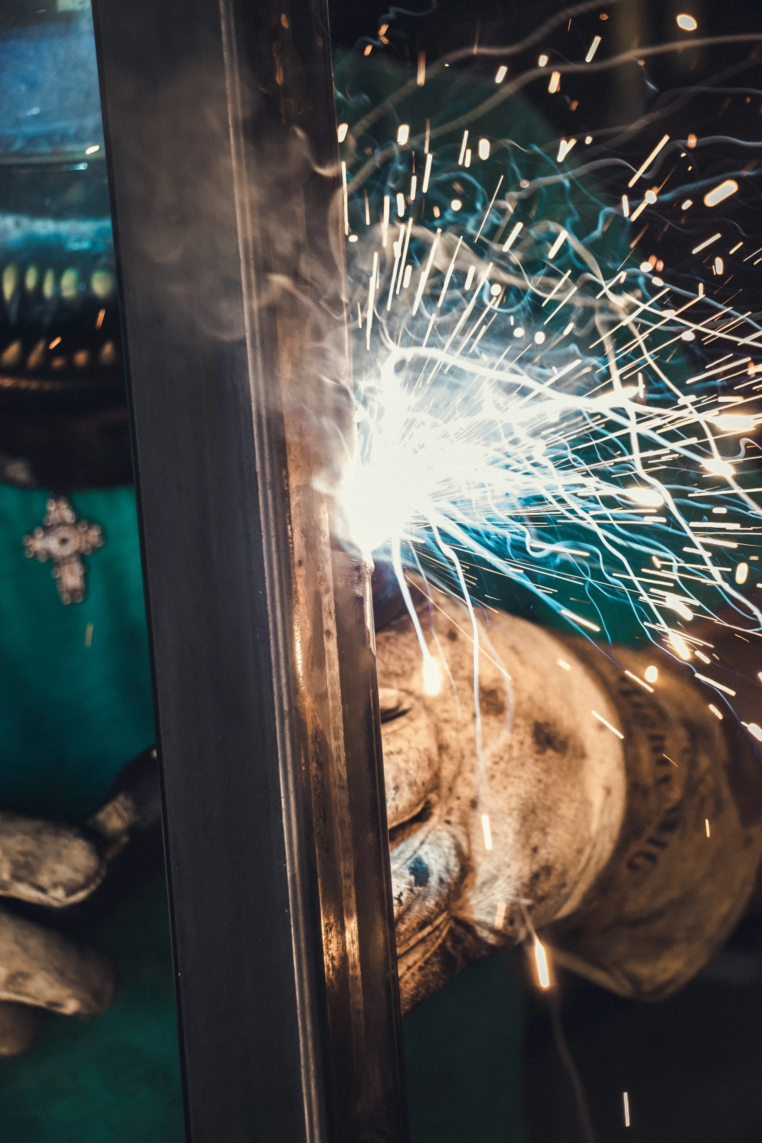 a person holding a metal device while welding