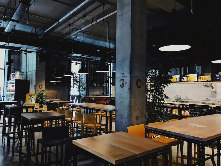 the dining area at the restaurant has many wooden tables