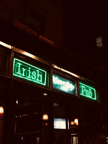 there is a restaurant called irish pub with two green neon signs
