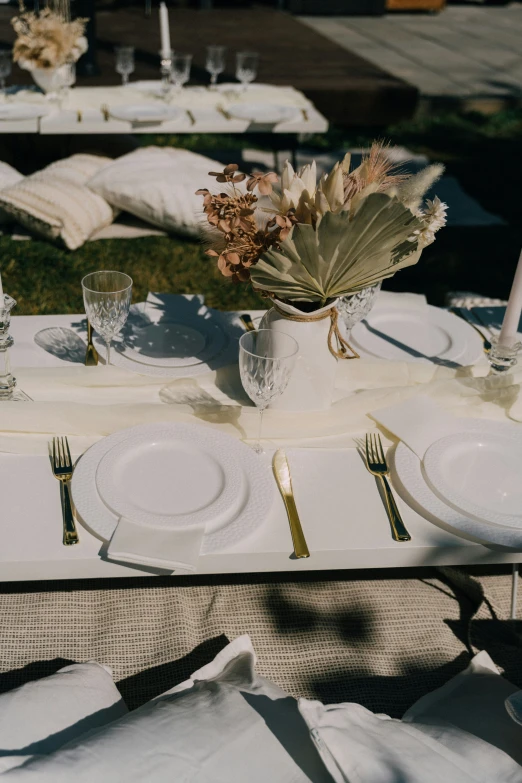 a white table setting with plates and place settings