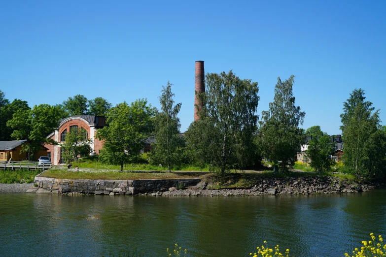 the view of a lake and an old factory