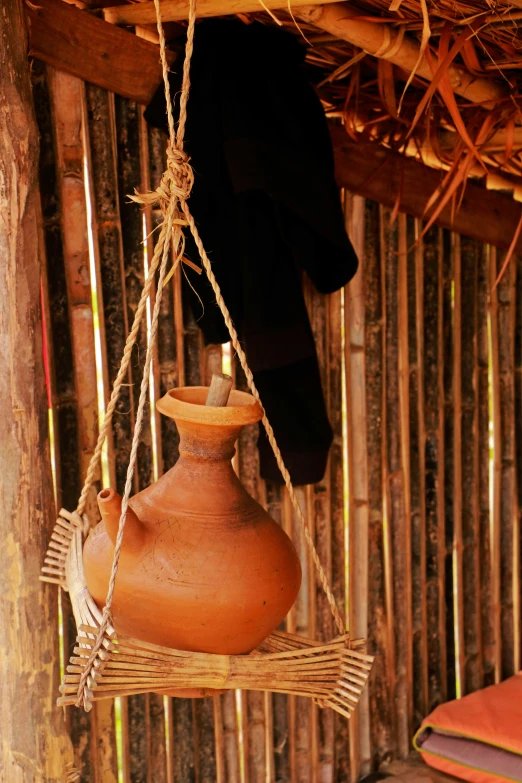 a clay pot suspended on a wire