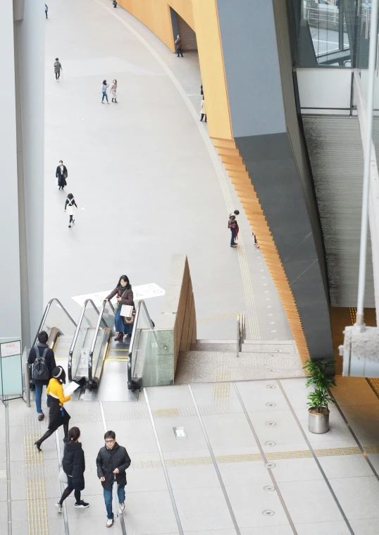 people going up and down an escalator in a building