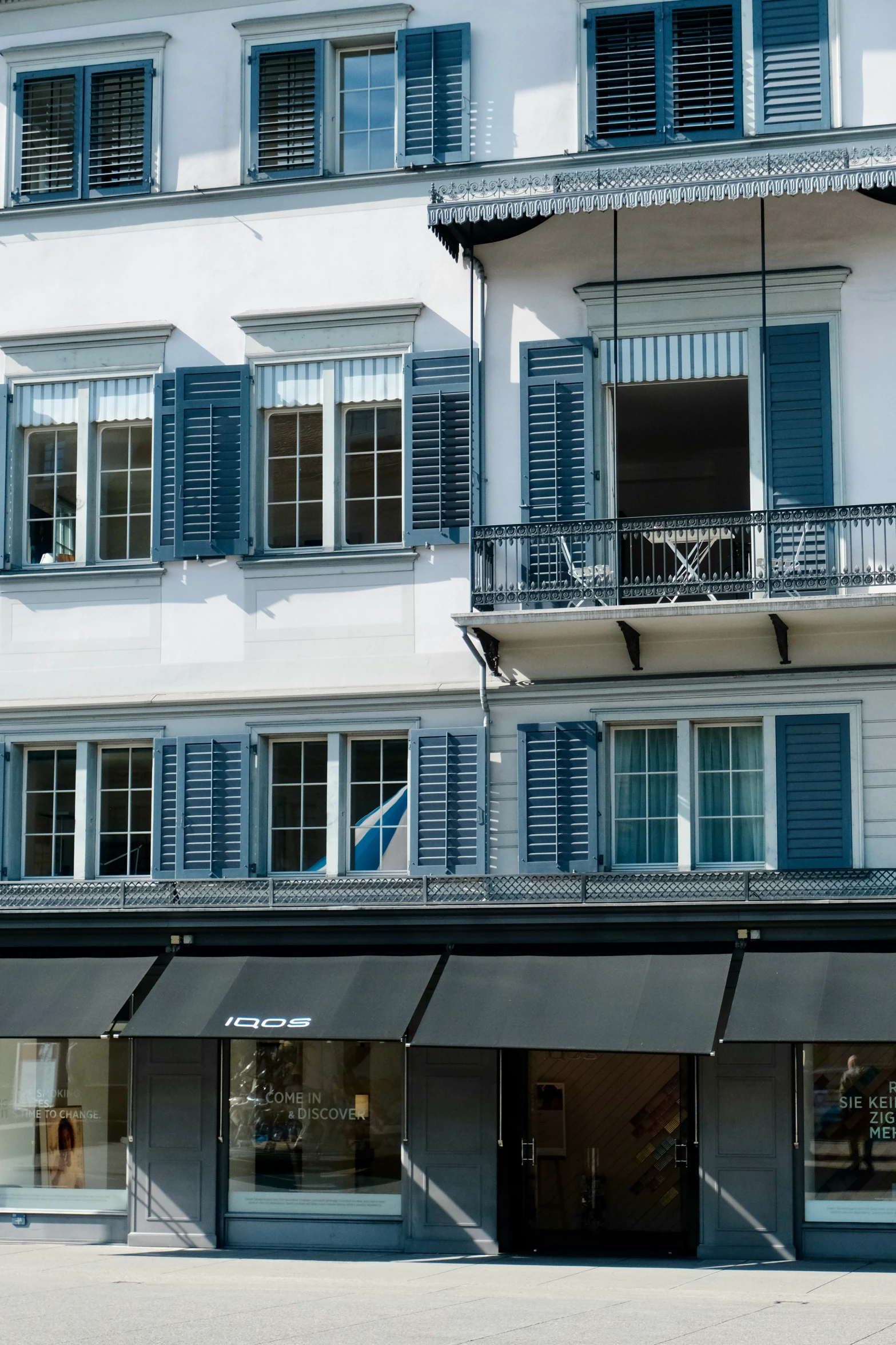 the building has windows with closed shutters