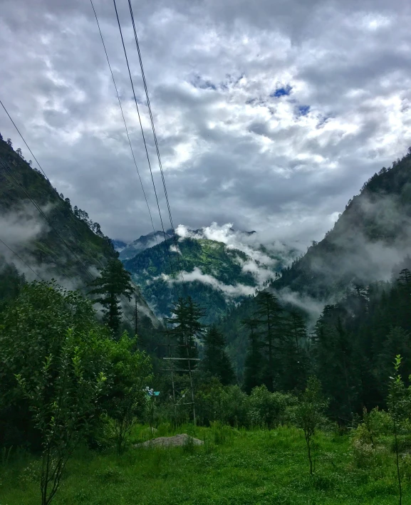 a landscape po of mountains and clouds in the background