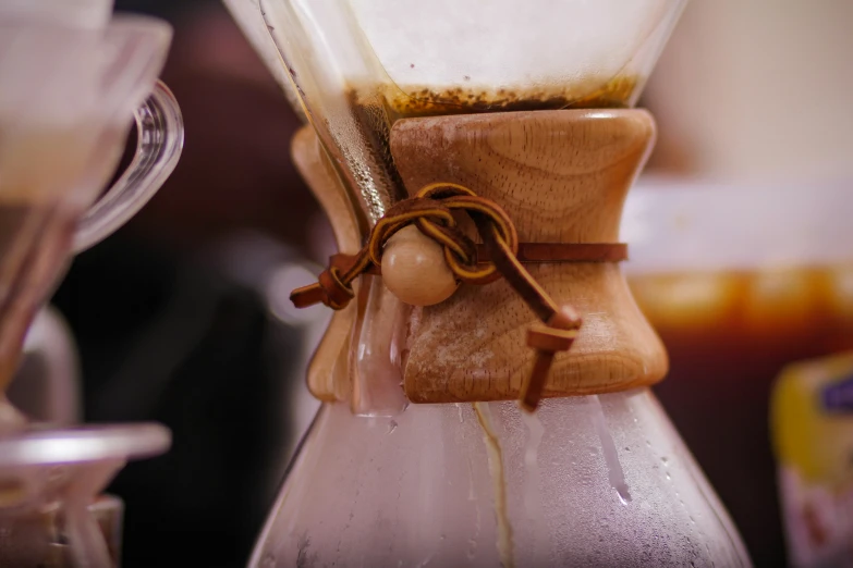 a wooden handle is attached to a clear blender