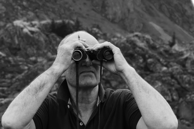 a man taking a po with binoculars