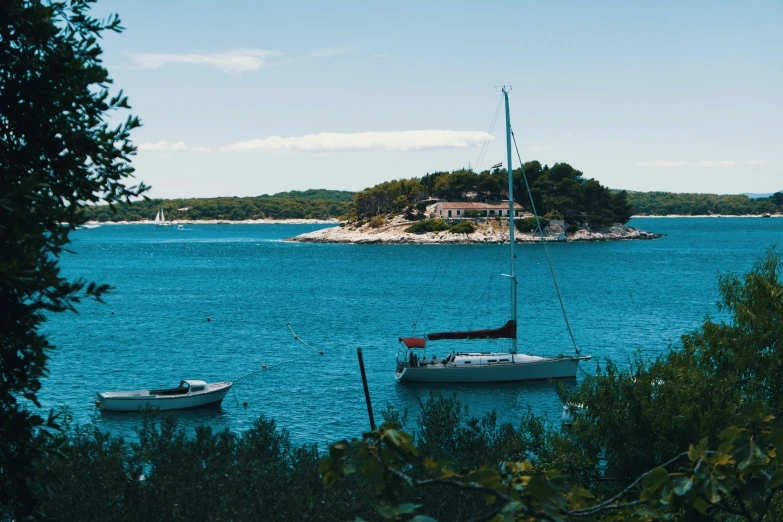 two boats in the water by a small island