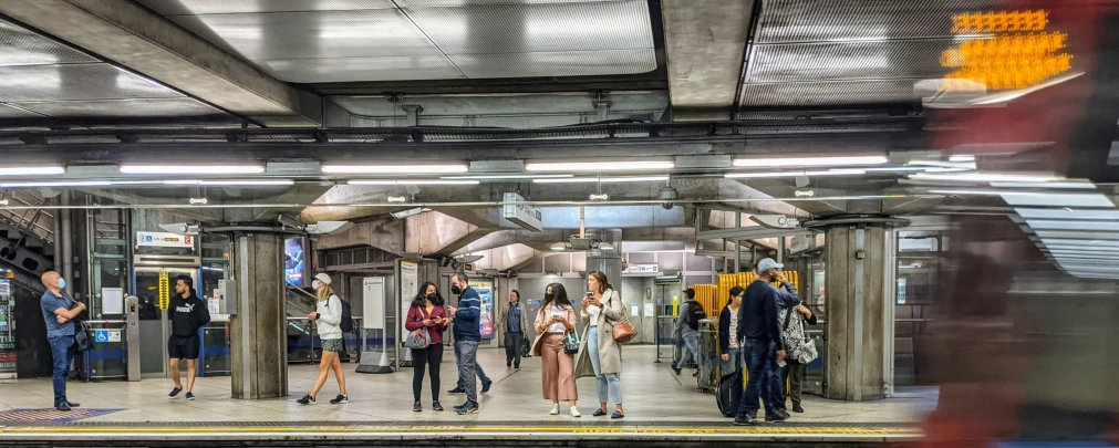 people walking in an empty train station