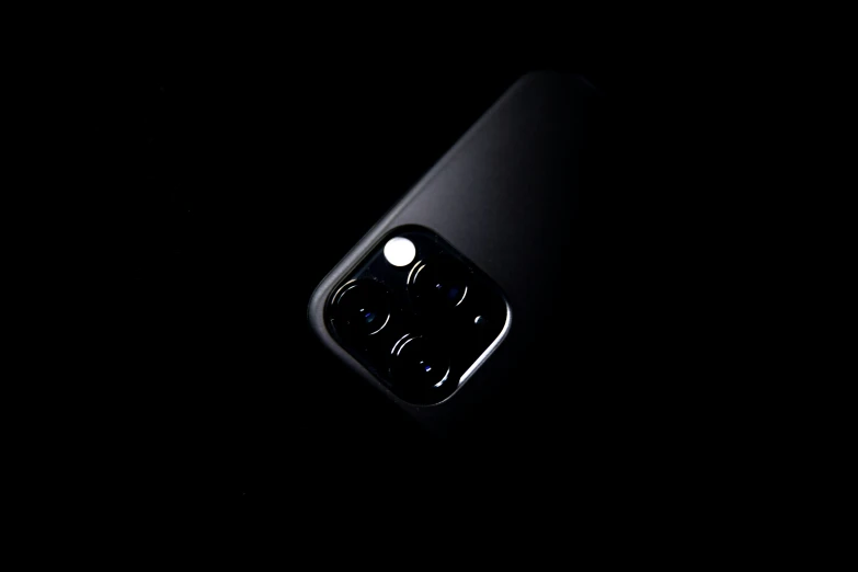 a cell phone laying in the dark with a blurry image behind it