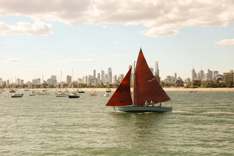 several boats out on the ocean near the city