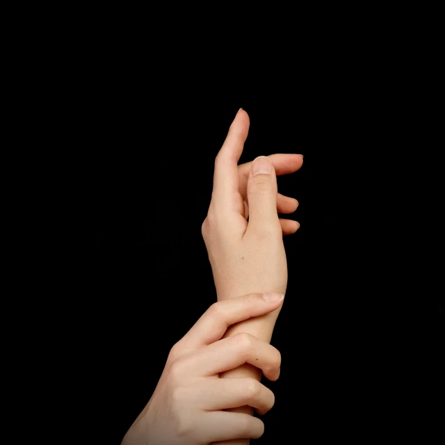 a person holding their hands together in the air
