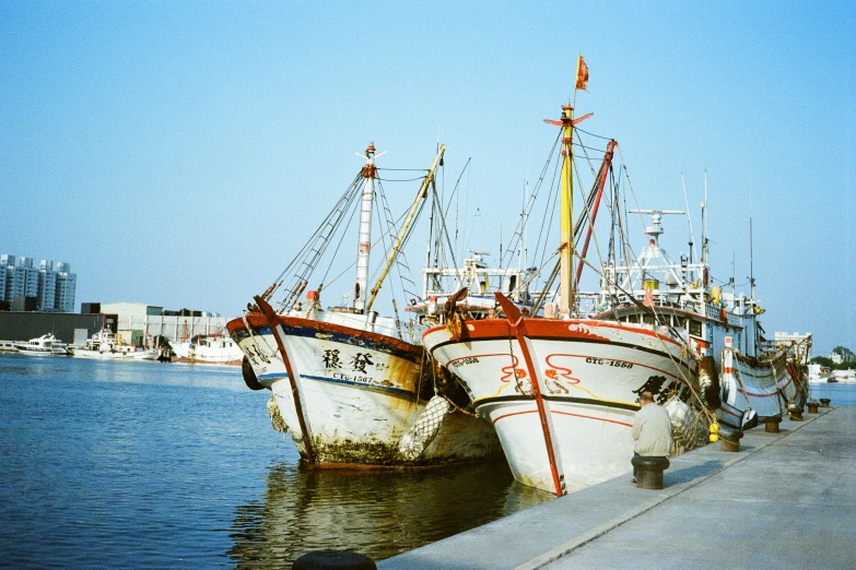 two ships sitting next to each other near the water