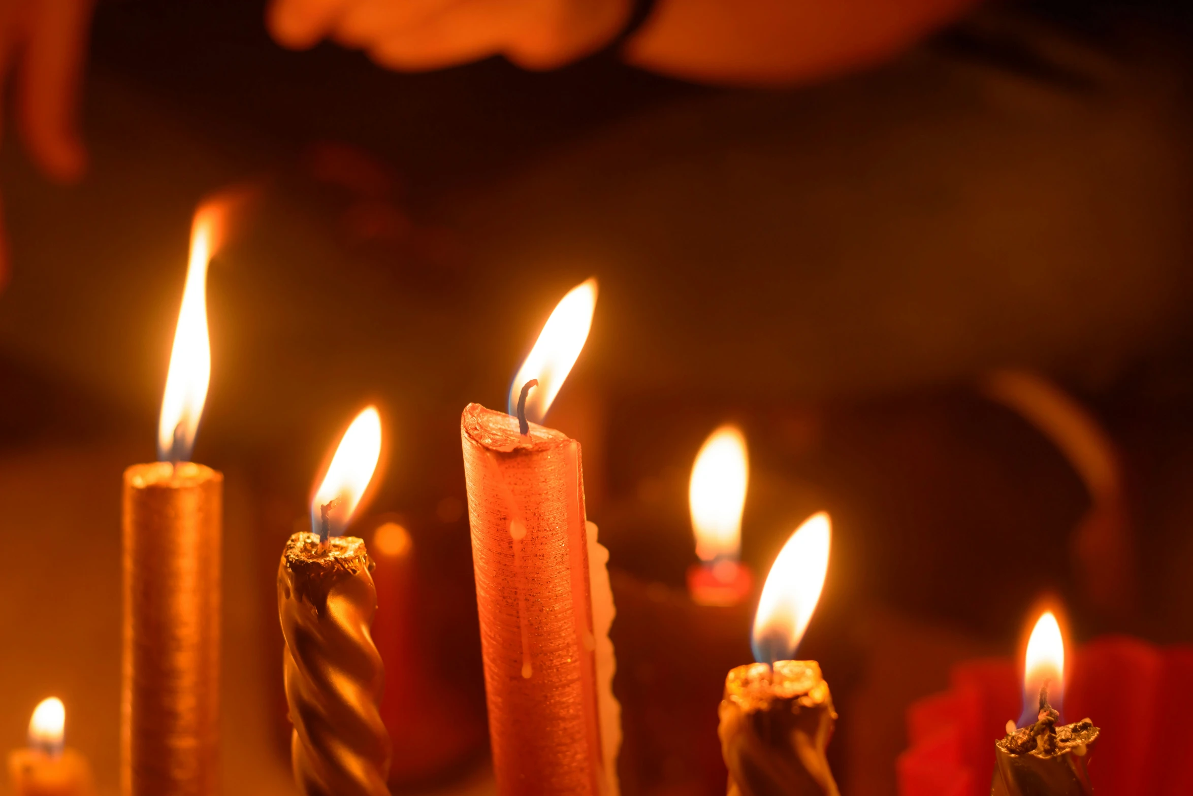 candles are lit in a darkened room, during the day