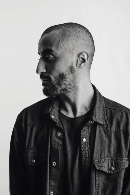 a man in denim jacket with a goatee and beard