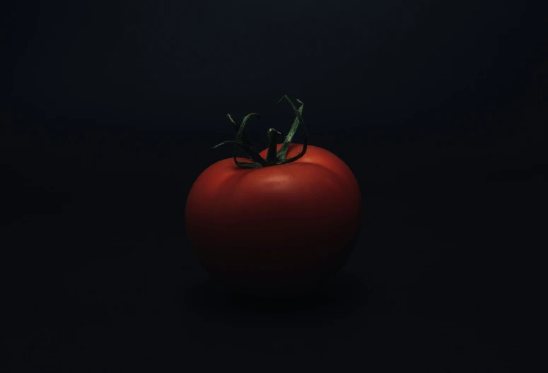 a large tomato is standing on the black table