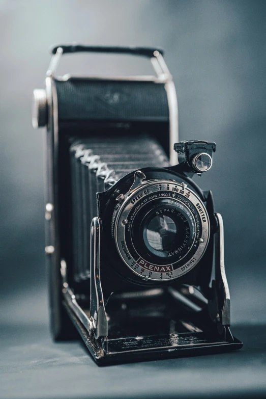 an antique po camera set against a gray background