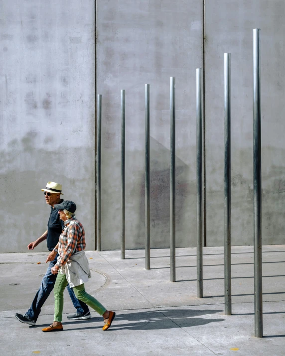 a man and a woman walk in an empty parking lot