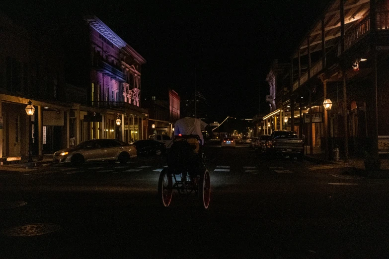 a couple of people on bicycles parked by some buildings