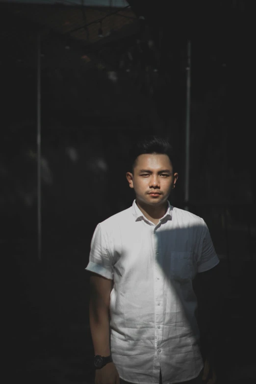 a young man in a white shirt and black tie