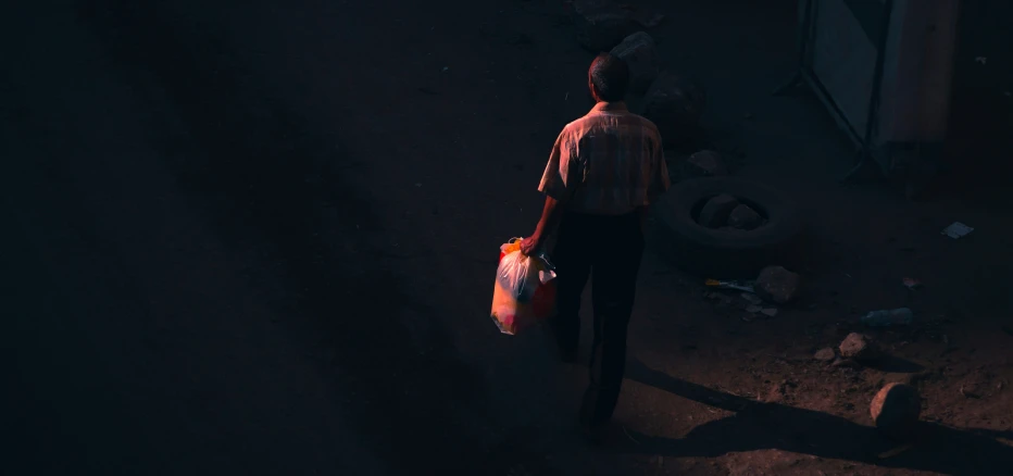 a man standing on a road holding soing