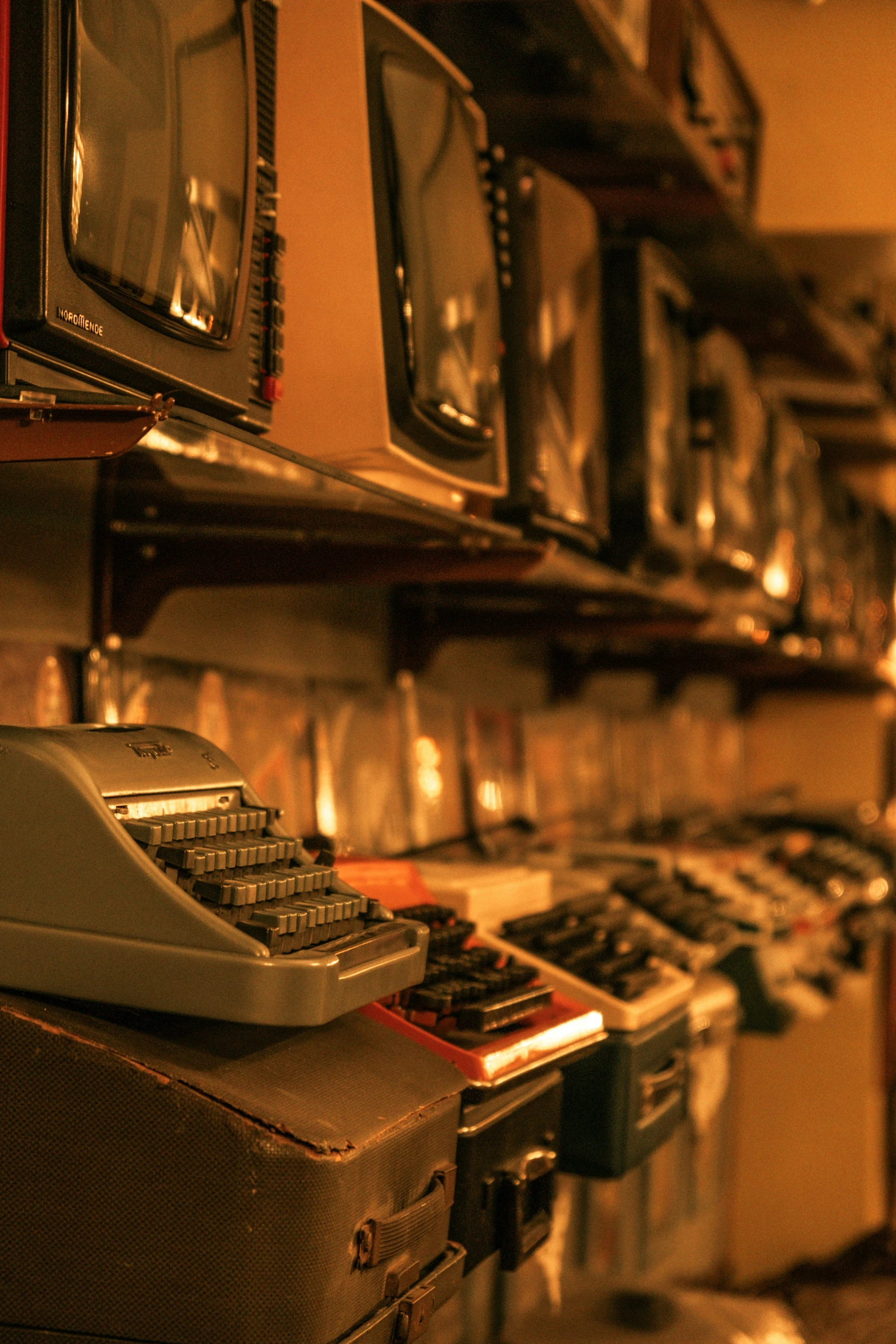 the old typewriter is on the table next to the wall of movies