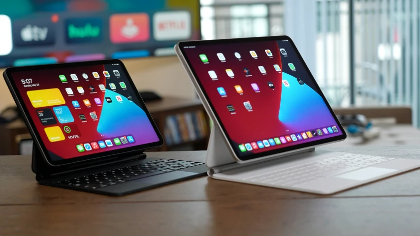 two tablets sitting side by side on a table