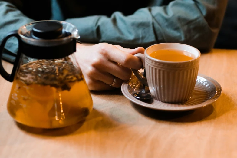 a person is holding on to the handle of a coffee cup