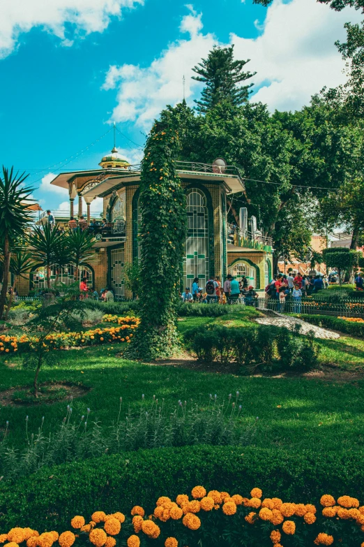 the flower garden of an exotic looking area with a gazebo in the distance