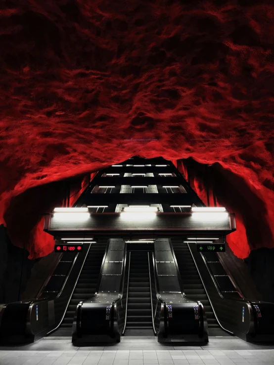 an escalator at the bottom of an underground tunnel