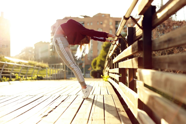 a person is leaning on a wooden bench