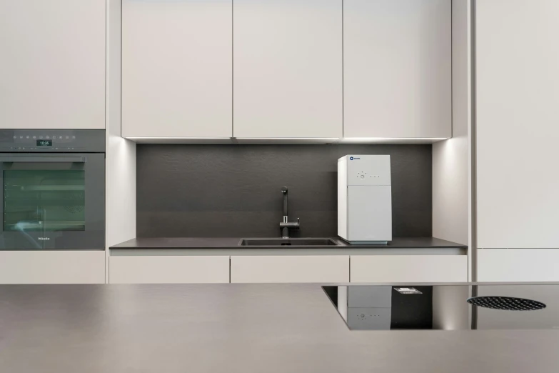 a small white kitchen with chrome counters