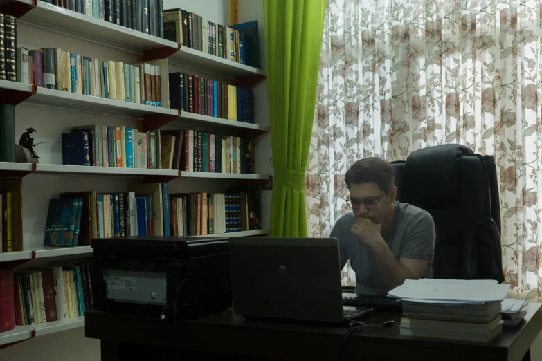 a man working on his laptop in the room