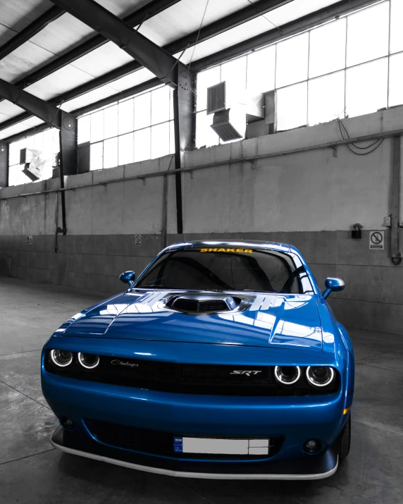 a blue dodge sr charge parked in a garage