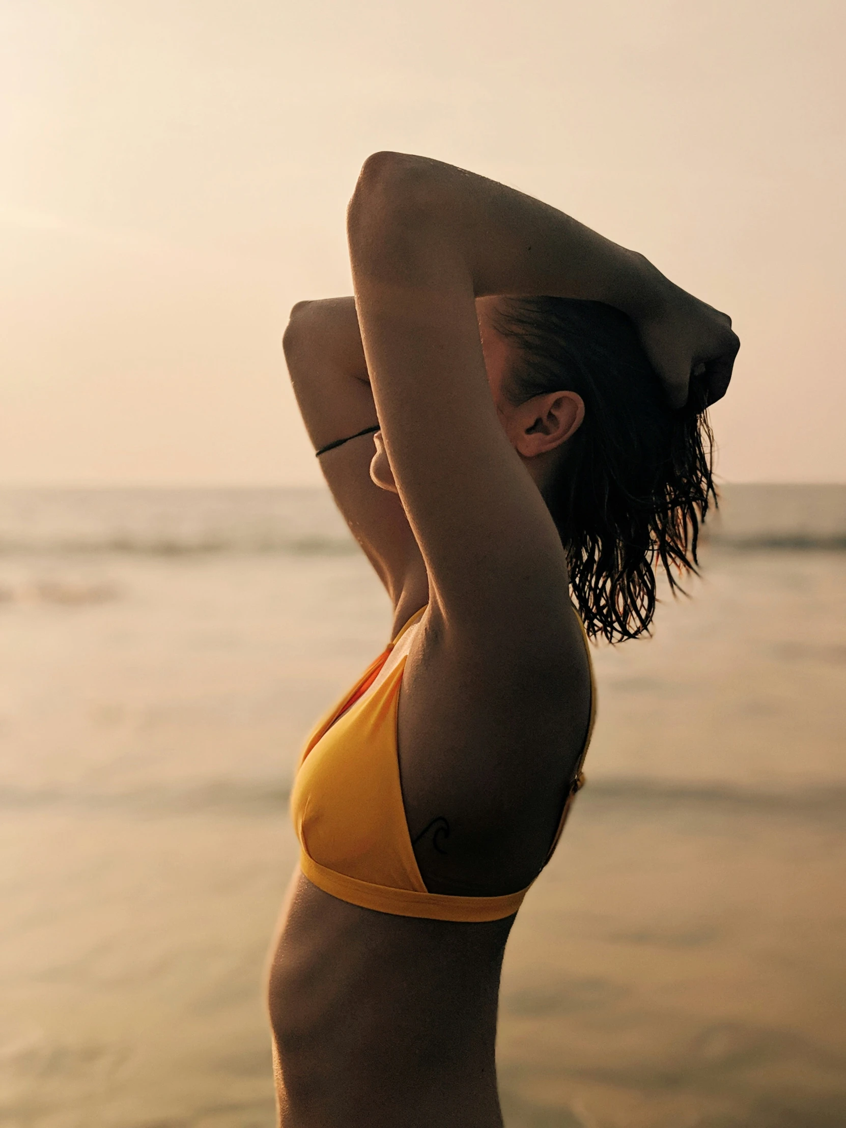 a young woman with an open head is on the beach