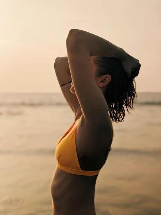 a young woman with an open head is on the beach