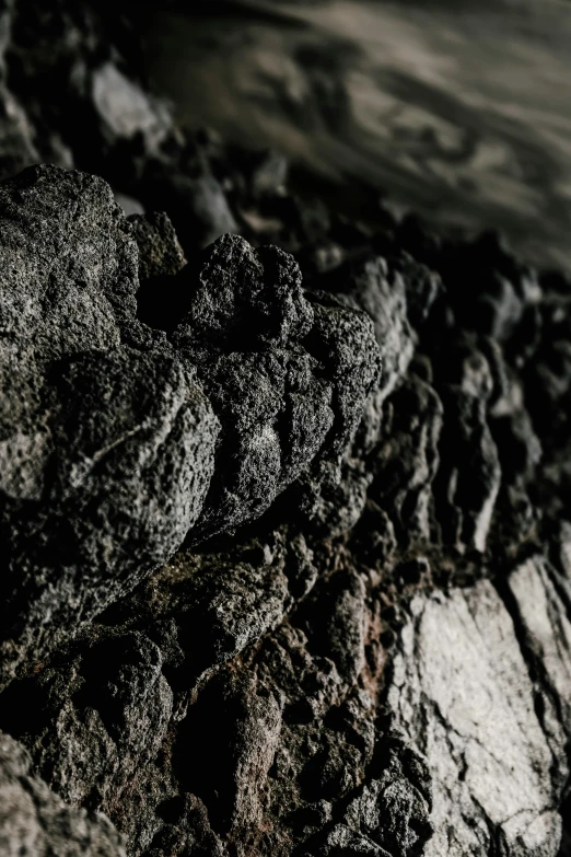 several black rocks with grey and white colors