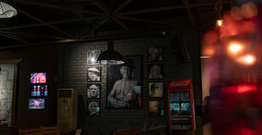 the lights of a restaurant adorns the walls with pictures of men