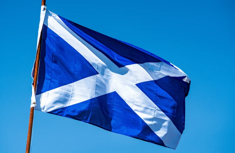 a large blue and white flag flying high