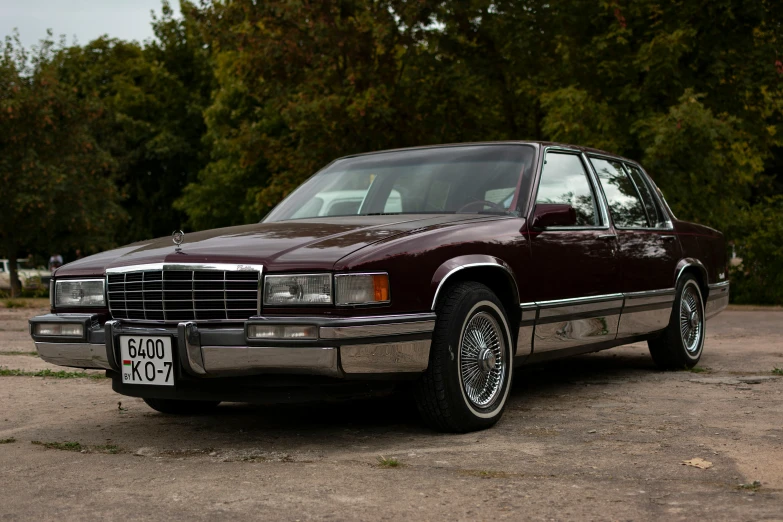 a maroon and black station wagon is parked in the parking lot