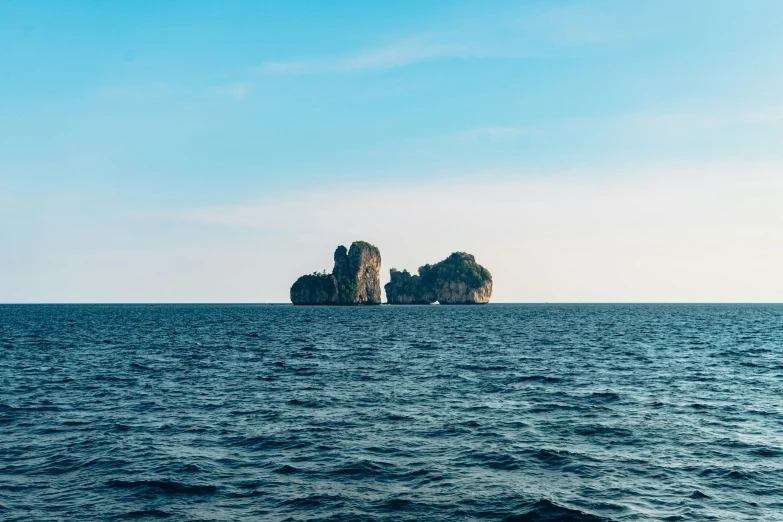 two small rock formations that are in the ocean