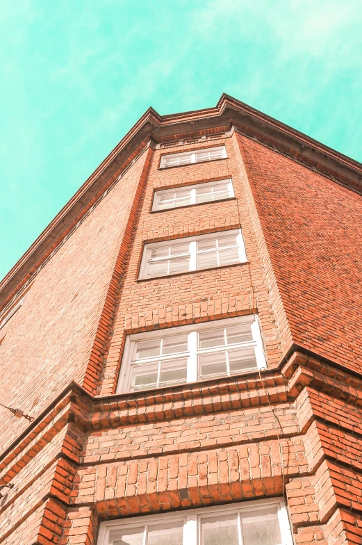 the top of a building with windows and brick